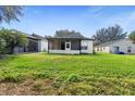 Large backyard with screened patio and grassy area at 927 Pecan St, Oviedo, FL 32765