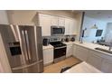 Stainless steel appliances and white shaker cabinets at 2774 Bright Bird Ln, Winter Park, FL 32792