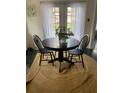 Small dining area with a round table and jute rug at 762 Rosalie Way, Winter Springs, FL 32708