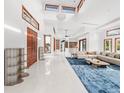 Spacious living area with high ceilings, large windows, and stylish furniture at 10230 Park Ridge Gotha Rd, Windermere, FL 34786