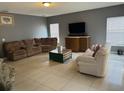 Spacious living room with tile floors and ample seating at 1403 Kissimmee Ct, Kissimmee, FL 34759
