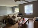 Cozy living room featuring a comfy couch and a coffee table at 1403 Kissimmee Ct, Kissimmee, FL 34759