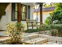 Relaxing front porch with wooden rocking chairs and brick steps at 2330 Westminster Ct, Winter Park, FL 32789