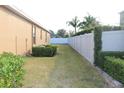 Grass backyard with a white vinyl fence at 428 Palastro Ave, Auburndale, FL 33823