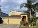 Two-story house with a two-car garage and manicured landscaping at 433 Eastbridge Dr, Oviedo, FL 32765