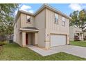 Two-story house with a white garage door and red front door at 510 Palm Ave, Eustis, FL 32726