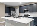 Modern kitchen with stainless steel appliances and an island at 510 Palm Ave, Eustis, FL 32726
