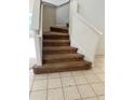 Indoor staircase with carpeted steps and neutral-colored walls at 1005 Chase Dr, Winter Garden, FL 34787