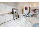 Bright kitchen with white cabinets, granite countertops, and stainless steel appliances at 110 Coleman St, Edgewater, FL 32141