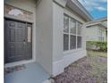 Dark gray front door and sidelights with a welcome mat at 1175 Chessington Cir, Lake Mary, FL 32746
