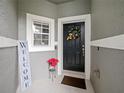 Welcoming front entry with decorative wreath and seasonal planter at 1542 Travertine Ter, Sanford, FL 32771