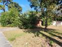 Brick house with overgrown landscaping at 1701 N Hastings St, Orlando, FL 32808