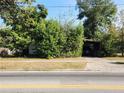 Ranch house obscured by overgrown vegetation at 1701 N Hastings St, Orlando, FL 32808