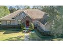 One-story house with a tile roof, landscaping, and a walkway at 25628 Hawks Run Ln, Sorrento, FL 32776