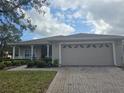 One-story house featuring a two-car garage and well-manicured lawn at 501 Heritage Trail St, Kissimmee, FL 34759