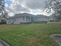 House with a large front yard, showcasing a side view of the home at 501 Heritage Trail St, Kissimmee, FL 34759