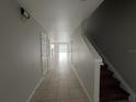 View of a hallway with tile floor and staircase at 572 Cresting Oak Cir # 19, Orlando, FL 32824