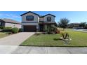 Two-story house with a landscaped yard and paved driveway at 684 Bishop Bay Loop, Apopka, FL 32712
