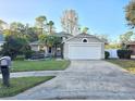 Tan house with white garage door and mailbox at 1022 Bartlett Ct, Oviedo, FL 32765