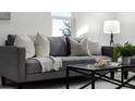 Cozy living room featuring a gray sofa, pillows, and a coffee table at 1441 Dann St, Orlando, FL 32804