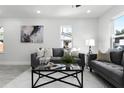 Modern living room with gray sofas, a glass coffee table, and a neutral rug at 1441 Dann St, Orlando, FL 32804