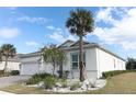 White house with two-car garage, palm tree, and well-maintained landscaping at 3449 Michigan St, Lake Mary, FL 32746