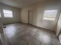 Simple bedroom with tile floors and window at 100 S Ortman Dr, Orlando, FL 32805