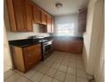 Kitchen with wood cabinets and stainless steel appliances at 100 S Ortman Dr, Orlando, FL 32805