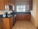 Kitchen with wood cabinets and stainless steel appliances at 100 S Ortman Dr, Orlando, FL 32805