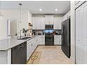 Modern kitchen with white cabinets, stainless steel appliances, and granite countertops at 12420 Turtle Grass Dr, Orlando, FL 32824