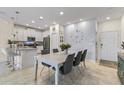 Bright eat-in kitchen with white cabinets, kitchen island, and dining area at 12420 Turtle Grass Dr, Orlando, FL 32824