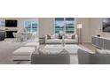 Spacious living room with light-colored furniture and large windows at 1245 Limbali St, Mount Dora, FL 32757