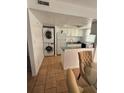 Kitchen with white cabinets, granite countertops, and a stackable washer/dryer at 2761 L B Mcleod Rd # C, Orlando, FL 32805