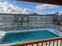 Community pool with surrounding patio furniture and building in background at 2761 L B Mcleod Rd # C, Orlando, FL 32805