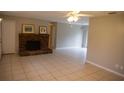 Spacious living room featuring a brick fireplace and tile floors at 3132 Pine Tree Dr, Edgewater, FL 32141