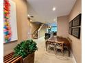 Bright dining area with wooden table and chairs, view into kitchen and living room at 3185 Brasilia Ave, Kissimmee, FL 34747