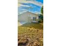 Newly built home with a small yard and light brown siding at 322 N 6Th St, Haines City, FL 33844