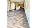 Open floor plan living room and kitchen with wood-look flooring at 322 N 6Th St, Haines City, FL 33844