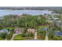 Aerial view of waterfront property with houses and lush trees at 6408 Shoreline Ct, St Cloud, FL 34771
