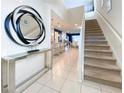Bright and spacious entryway with stairs and a large mirror at 8956 Zurich Ln, Kissimmee, FL 34747