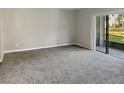 Spacious living room with gray carpeting and sliding glass doors at 152 Springwood Cir # B, Longwood, FL 32750