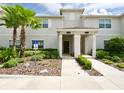 Two-story townhome with welcoming front porch and landscaping at 1604 Moon Valley Dr, Davenport, FL 33896