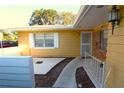 Front entrance of a yellow single-story home with a walkway and brick accents at 2214 Winnetka Ct, Orlando, FL 32818