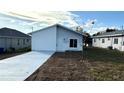 Newly built home featuring a contemporary design and a paved driveway at 314 N 6Th St, Haines City, FL 33844