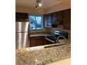 Modern kitchen with stainless steel appliances and granite countertops at 327 Scottsdale Sq # 327, Winter Park, FL 32792