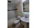 Clean bathroom with a bathtub, toilet and pedestal sink at 348 Scottsdale Sq # 348, Winter Park, FL 32792