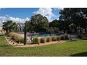 Clean community pool area with grassy lawn at 5850 Cypress Gardens Blvd # 304, Winter Haven, FL 33884