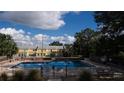Refreshing community pool with surrounding landscaping at 5850 Cypress Gardens Blvd # 304, Winter Haven, FL 33884