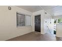 Private condo entry with dark brown door and tiled flooring at 6110 Curry Ford Rd # 219, Orlando, FL 32822