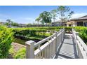 Wooden footbridge over a tranquil waterway at 6110 Curry Ford Rd # 219, Orlando, FL 32822